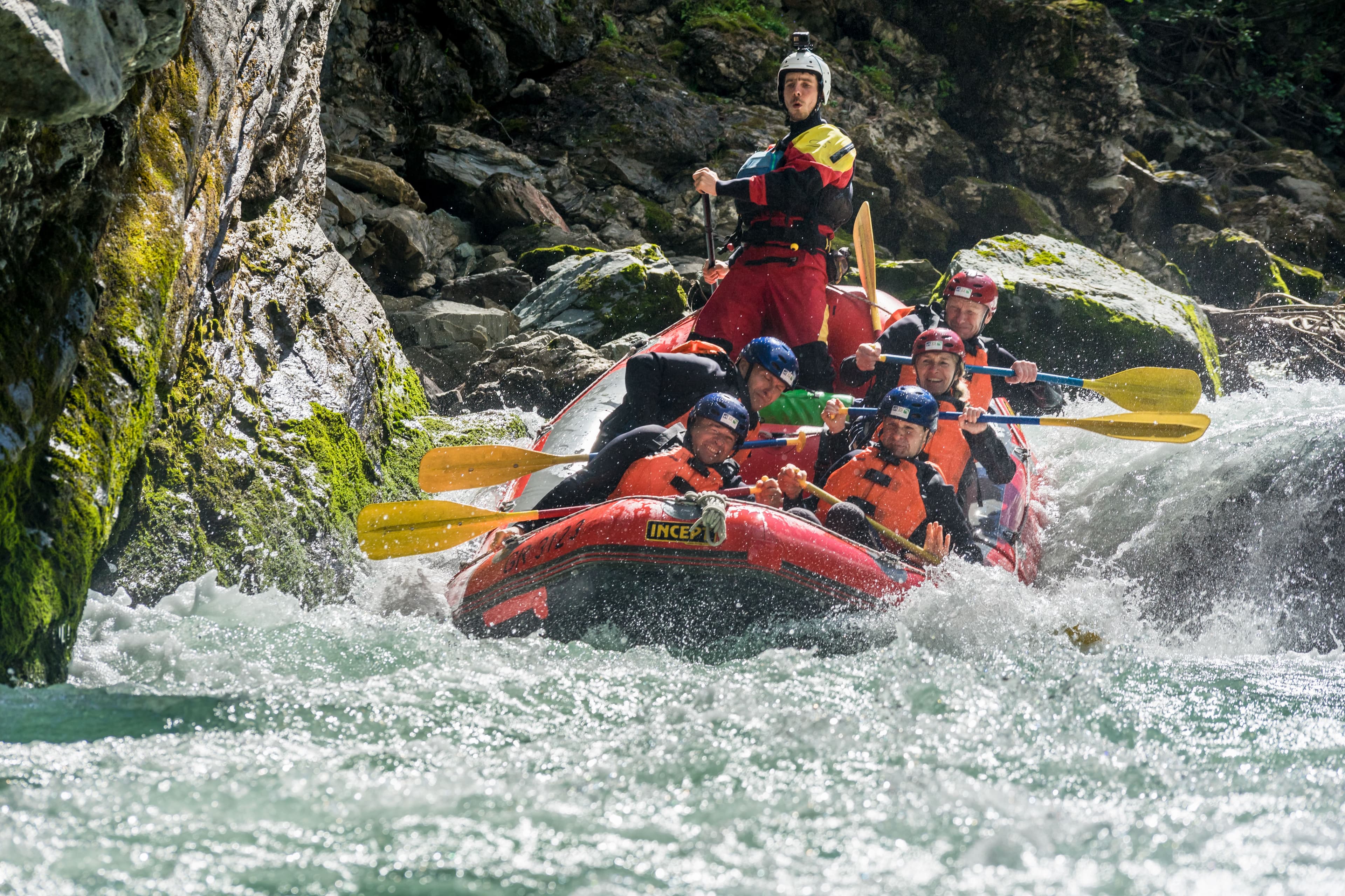 White Water Rafting Adventure in Giarsun Engadin with participants in a raft on turbulent waters.