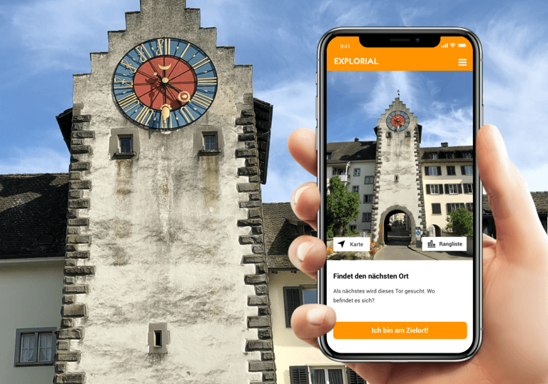 Mobile treasure hunt in Stein am Rhein, background with clock tower, fascinating old town.