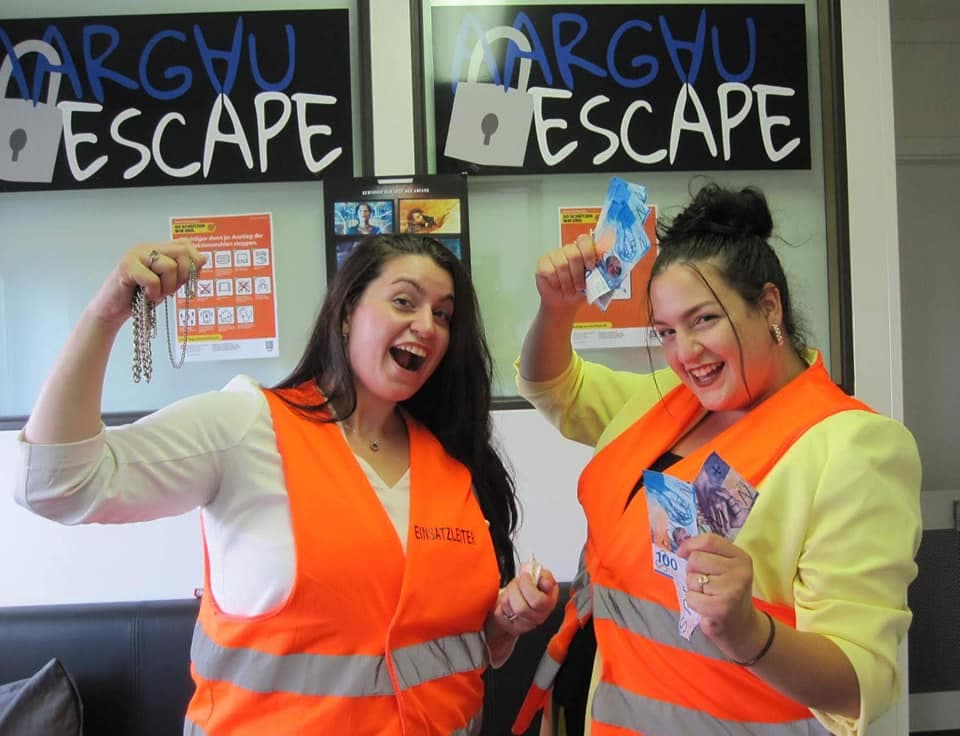 Escape room with participants in safety vests presenting evidence.